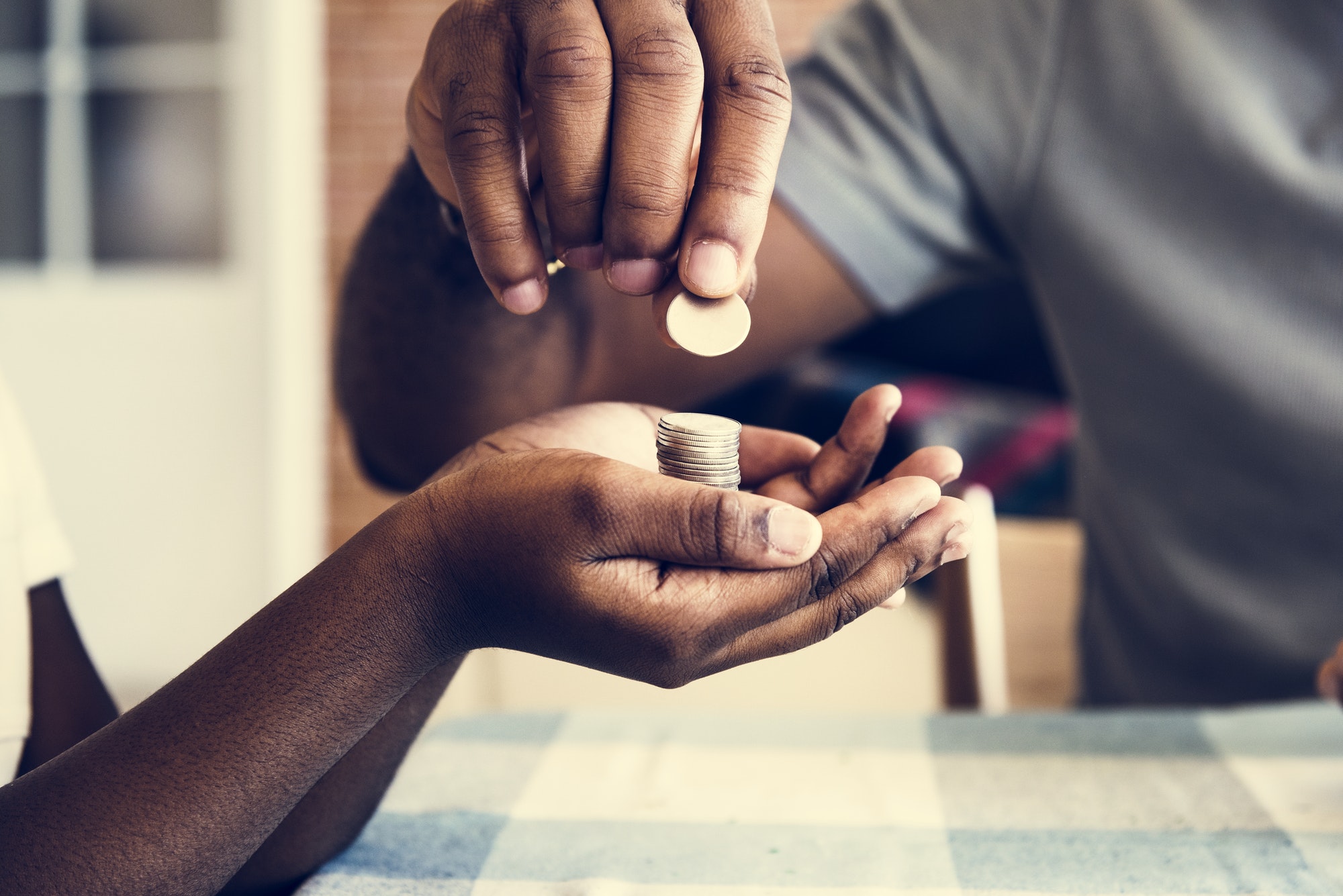 Dad giving coins to his daughter