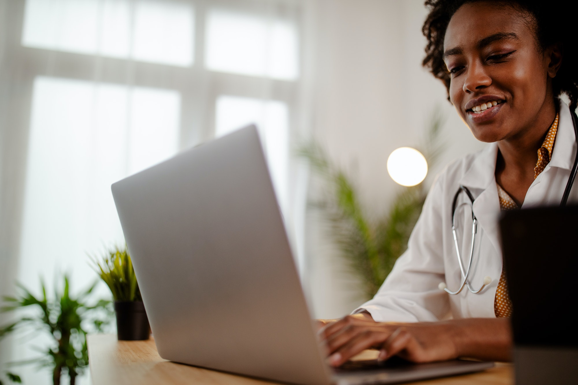 The female doctor sitting and checking the patient's history.